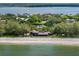 Wide aerial showcasing home's beachfront location at 8440 Sanderling Rd, Sarasota, FL 34242