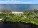 Aerial view of waterfront home with private beach access at 8440 Sanderling Rd, Sarasota, FL 34242