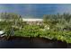 Aerial view of waterfront home with beach access at 8440 Sanderling Rd, Sarasota, FL 34242