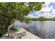 Kayak rests on a wooden dock overlooking a peaceful waterway at 8440 Sanderling Rd, Sarasota, FL 34242