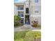Exterior view of an apartment building with stairs and landscaping at 5122 Northridge Rd # 107, Sarasota, FL 34238