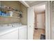 Laundry room with side-by-side washer and dryer and extra shelving at 5122 Northridge Rd # 107, Sarasota, FL 34238