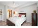 Bedroom with a floral comforter, dark wood frame bed, and ceiling fan at 5122 Northridge Rd # 107, Sarasota, FL 34238