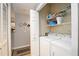 Bright laundry room with washer, dryer, and shelving for storage at 5122 Northridge Rd # 107, Sarasota, FL 34238