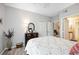 Bedroom with a floral comforter, dark wood frame bed, and ceiling fan at 5122 Northridge Rd # 107, Sarasota, FL 34238
