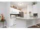 Well-equipped kitchen with white cabinets, granite counters, and stainless steel appliances at 5122 Northridge Rd # 107, Sarasota, FL 34238