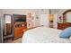 Main bedroom with wood furniture and a view of the en-suite bathroom at 5122 Northridge Rd # 107, Sarasota, FL 34238