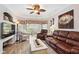 Elegant living room with leather furniture, large TV, and access to a patio at 5122 Northridge Rd # 107, Sarasota, FL 34238