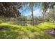 Serene pond surrounded by lush greenery and trees at 5122 Northridge Rd # 107, Sarasota, FL 34238