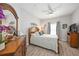 Bright bedroom with wood-framed bed, dresser, and plenty of natural light at 5122 Northridge Rd # 107, Sarasota, FL 34238