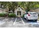 Condo building entrance with parking and landscaped grounds at 5122 Northridge Rd # 107, Sarasota, FL 34238