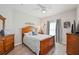 Bright bedroom with wood-framed bed, dresser, and plenty of natural light at 5122 Northridge Rd # 107, Sarasota, FL 34238