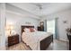 Bedroom with a floral comforter, dark wood frame bed, and ceiling fan at 5122 Northridge Rd # 107, Sarasota, FL 34238