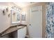 Bathroom features granite countertop, white cabinets, and a walk-in shower at 5122 Northridge Rd # 107, Sarasota, FL 34238