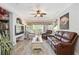 Spacious living room with a leather couch and access to a balcony at 5122 Northridge Rd # 107, Sarasota, FL 34238
