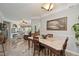 Open concept dining room with a view of the living room and access to the kitchen at 5122 Northridge Rd # 107, Sarasota, FL 34238