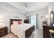 Bedroom with a floral comforter, dark wood frame bed, and ceiling fan at 5122 Northridge Rd # 107, Sarasota, FL 34238
