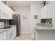 Modern kitchen boasts white cabinets, granite countertops, and stainless steel appliances at 5122 Northridge Rd # 107, Sarasota, FL 34238