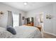 Bedroom with wood furniture and a view of the en-suite bathroom at 5122 Northridge Rd # 107, Sarasota, FL 34238