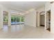 Bright living room featuring white tile floors, recessed lighting, and access to a pool area with large glass sliding doors at 7602 Partridge Street Cir, Bradenton, FL 34202