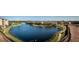 Community lake with walking path, landscaping, and condo buildings at 9957 Key Haven Rd, Seminole, FL 33777