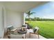 Relaxing patio with fire pit and comfortable seating overlooking a green space at 9957 Key Haven Rd, Seminole, FL 33777