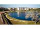 Community pond with walking path and buildings at 9957 Key Haven Rd, Seminole, FL 33777