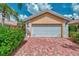 Home with white garage door and brick driveway at 11624 Garessio Ln, Sarasota, FL 34238