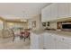 Open concept kitchen with white cabinets, granite countertops, and views to the Gathering room at 11624 Garessio Ln, Sarasota, FL 34238