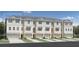 Three-story townhomes with attached garages and modern facade at 9967 Key Haven Rd # 19, Seminole, FL 33777