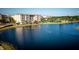 Aerial view showcasing community lake and buildings with tennis courts at 9967 Key Haven Rd # 19, Seminole, FL 33777