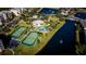 Aerial view of community pool, tennis courts, and lake at 9947 Key Haven Rd, Seminole, FL 33777