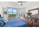 King bedroom with stunning outdoor views and ceiling fan at 409 N Point Rd # 502, Osprey, FL 34229