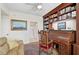 Home office with built-in desk and bookshelves, plus a comfortable couch at 409 N Point Rd # 502, Osprey, FL 34229