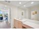 Bright bathroom with vanity, toilet, and mirrored walls at 409 N Point Rd # 502, Osprey, FL 34229
