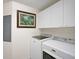 Convenient laundry room with side-by-side washer and dryer at 409 N Point Rd # 502, Osprey, FL 34229