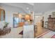 Open concept kitchen with wood cabinets and granite countertops at 409 N Point Rd # 502, Osprey, FL 34229