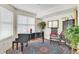Elegant music room with baby grand piano and antique furniture at 409 N Point Rd # 502, Osprey, FL 34229