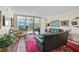 Living room with leather sofas, balcony access and scenic view at 409 N Point Rd # 502, Osprey, FL 34229