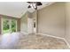 Spacious bedroom with tile flooring and access to the backyard at 337 Snapdragon Loop, Bradenton, FL 34212