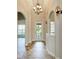 Elegant entryway with tile flooring, arched doorways, and a stunning chandelier at 337 Snapdragon Loop, Bradenton, FL 34212