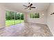 Gathering room with sliding doors to backyard and tile floors at 337 Snapdragon Loop, Bradenton, FL 34212