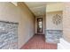 Covered entryway with stonework and a decorative metal accent at 337 Snapdragon Loop, Bradenton, FL 34212