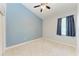 Well-lit bedroom with light blue walls and carpet flooring at 337 Snapdragon Loop, Bradenton, FL 34212