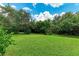 Private backyard with lush lawn and mature trees at 337 Snapdragon Loop, Bradenton, FL 34212