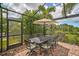 Covered patio with table, chairs, and umbrella; perfect for outdoor dining at 8104 36Th E St, Sarasota, FL 34243