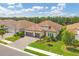 Beautiful single-Gathering home featuring a red tile roof, paver driveway, lush landscaping, and a two-car garage at 13212 Deep Blue Pl, Lakewood Ranch, FL 34211