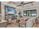 Stunning living room with a decorative fireplace, wood ceiling beams, and an expansive window overlooking the backyard at 13212 Deep Blue Pl, Lakewood Ranch, FL 34211