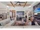 Open-concept living area showcasing a stylish wet bar with glass cabinets and modern furnishings and fireplace at 13212 Deep Blue Pl, Lakewood Ranch, FL 34211