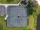 Aerial view of well-maintained tennis courts and surrounding landscaped grounds at 2330 Little Country Rd, Parrish, FL 34219